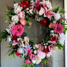 A pink and red door wreath