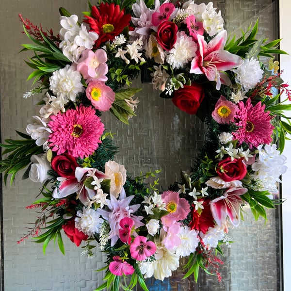 A pink and red door wreath