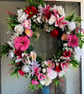 A pink and red door wreath