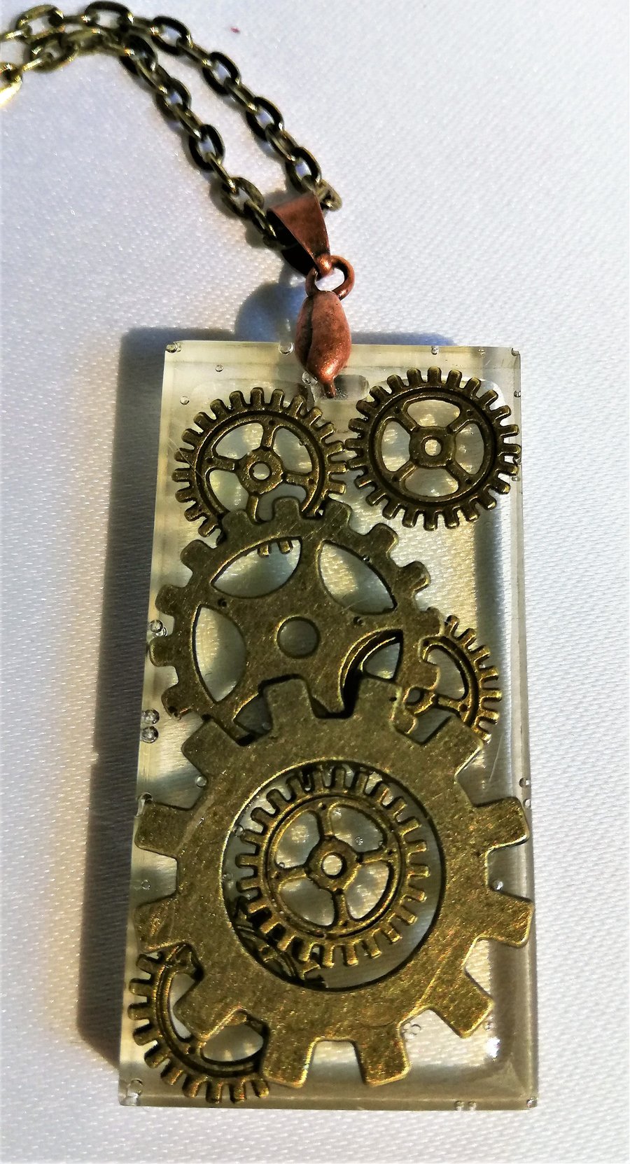 Handmade steampunk resin necklace with bronze cogs and gears