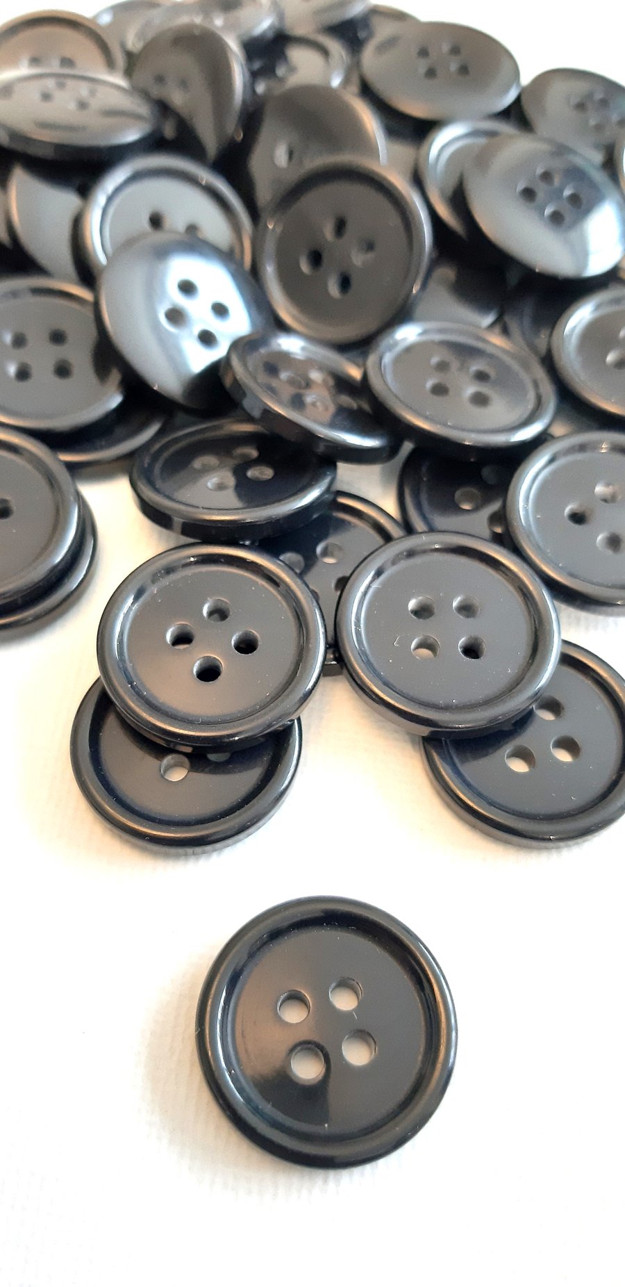 15mm, 4-hole black glossy buttons, with a raised outer edge