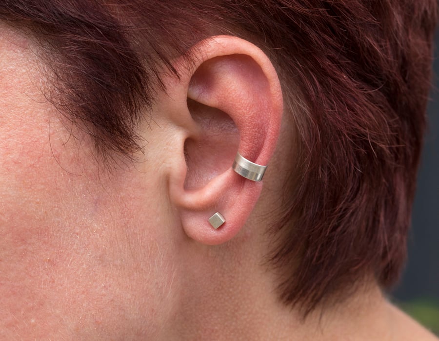 Slim silver ear cuff with a two tone texture, brush matte and mirror polished
