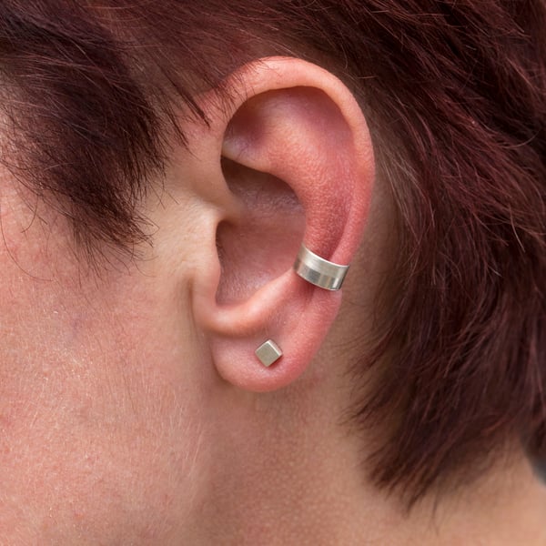 Slim silver ear cuff with a two tone texture, brush matte and mirror polished