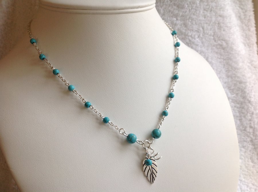 Turquoise colour silver leaf charm necklace 17 inches.