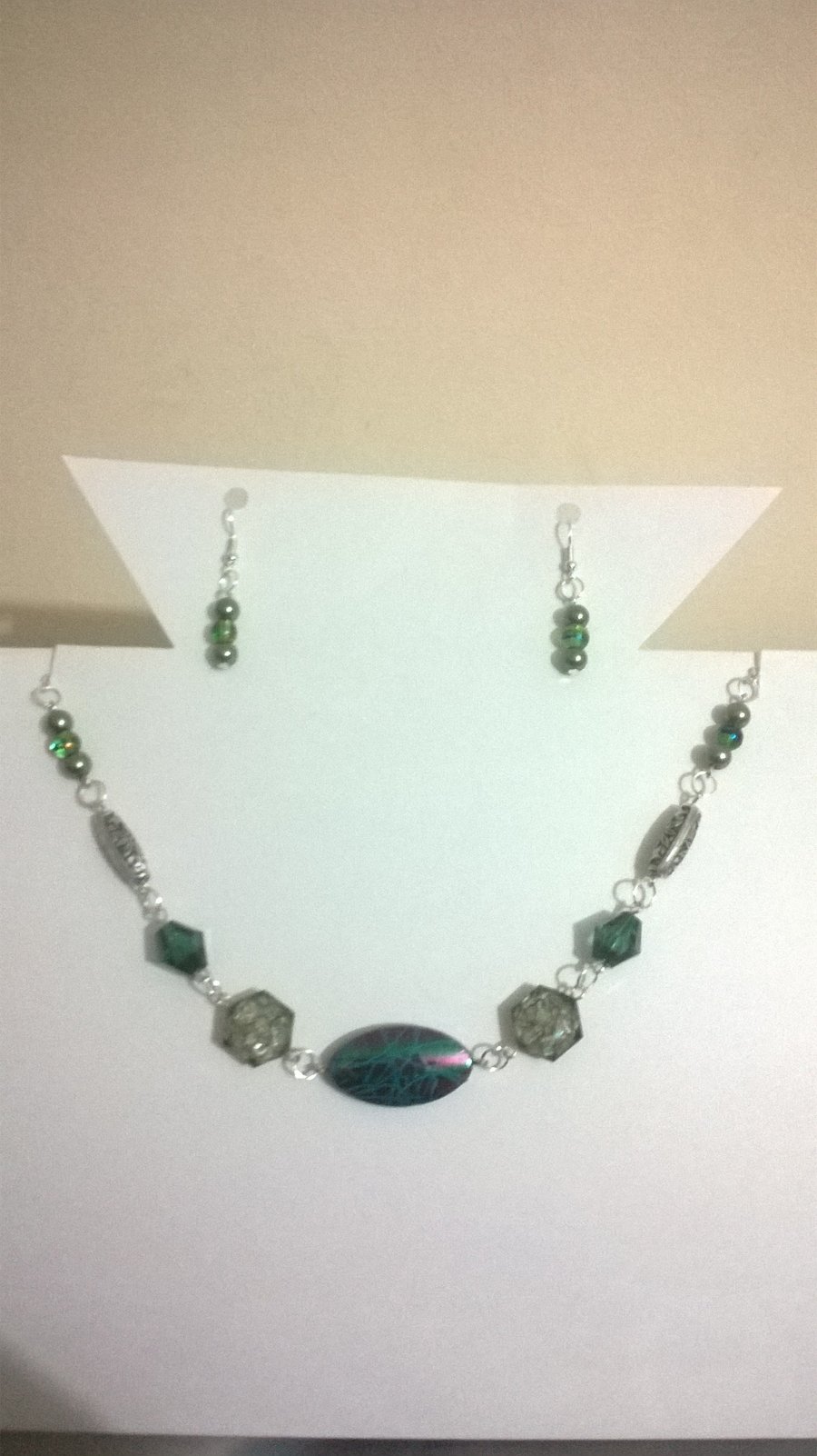 Multi shade green necklace and earring set with silver plated findings.