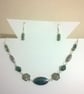 Multi shade green necklace and earring set with silver plated findings.