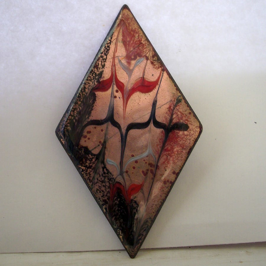 brooch: diamond shape - scrolled red and black over clear enamel