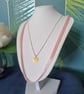 Pastel pink ribbon necklace with silver chain and gold pendant 