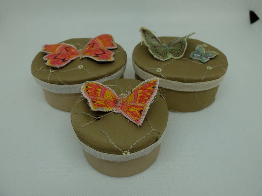 Set of three round and oval gift boxes, gold with butterflies