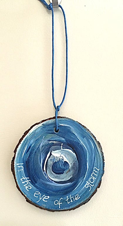 In the eye of the storm all is calm. Hand painted wood slice wall hanging. 