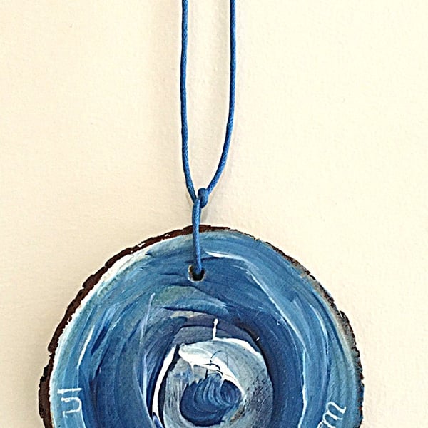 In the eye of the storm all is calm. Hand painted wood slice wall hanging. 