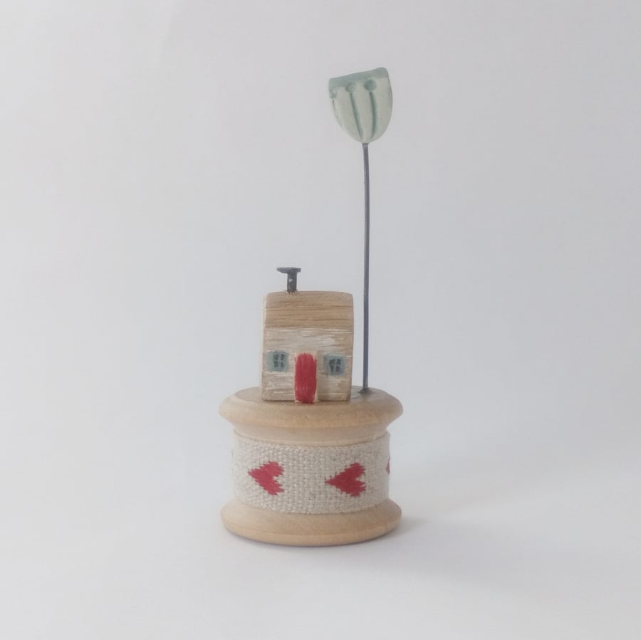 Tiny oak house on vintage bobbin with clay flower 