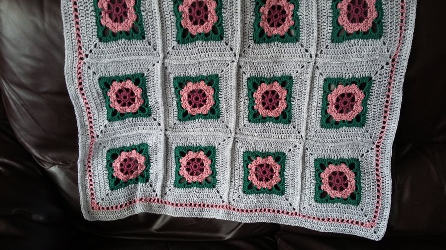 Crochet Rose Blanket made with pink rose motifs on a silver surround