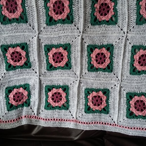 Crochet Rose Blanket made with pink rose motifs on a silver surround