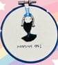Embroidery hoop with motivational quote of a girl “hanging on” upside down  - Image 3
