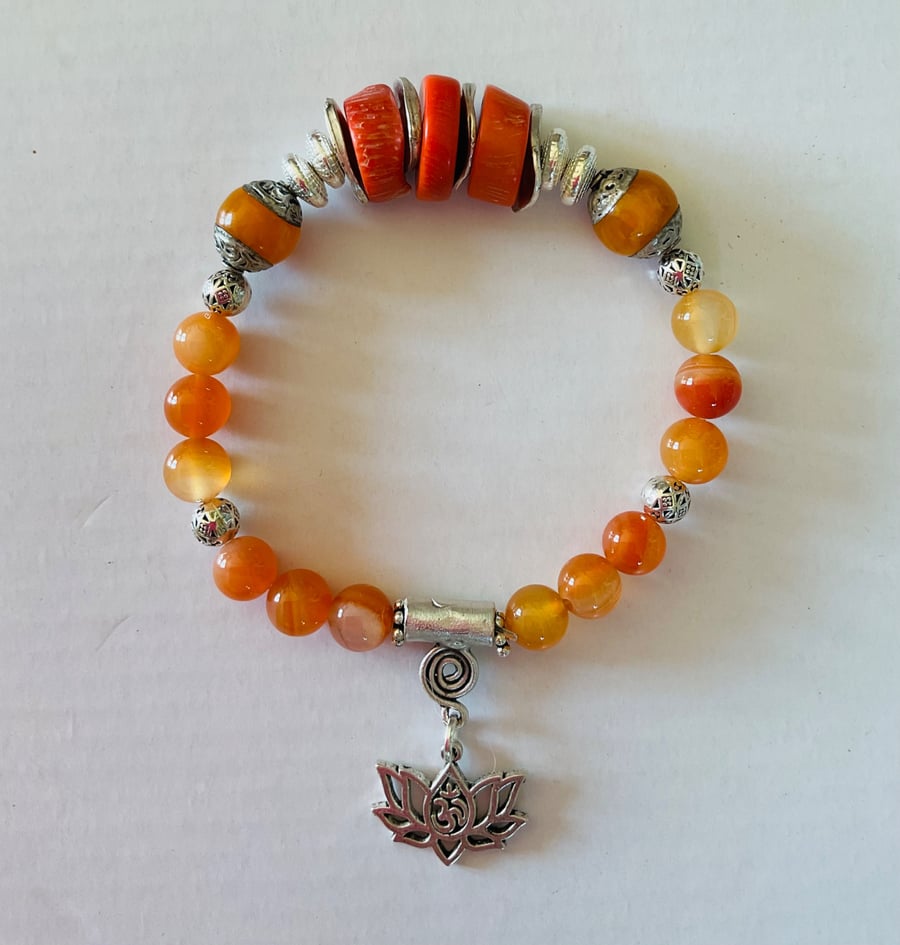 Semiprecious stone charm bracelet featuring deep sea coral and carnelian