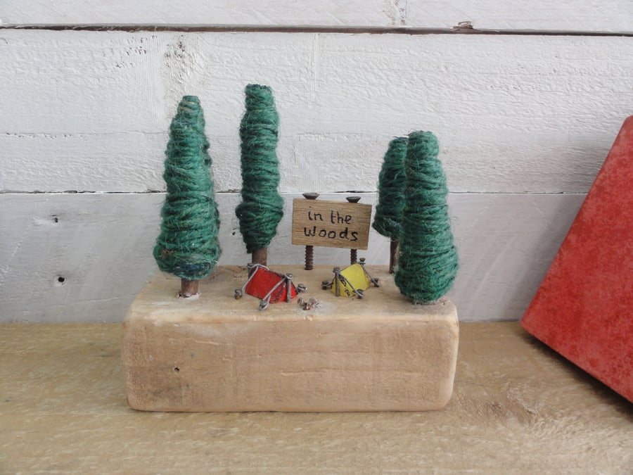 Little wooden tent in miniature camping scene of reclaimed materials