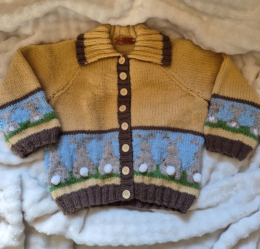 Handknit fairisle children's cardigan with pom pom bunnies