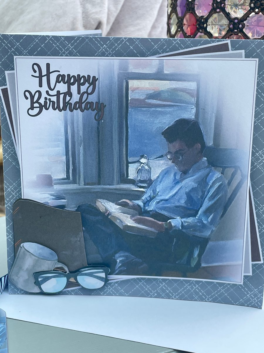 Chilled and relaxed man reading Happy birthday card