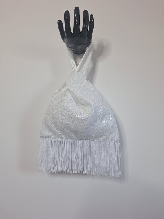 White sequin Japanese Knot bag with 9cm tassel trim and satin lining.