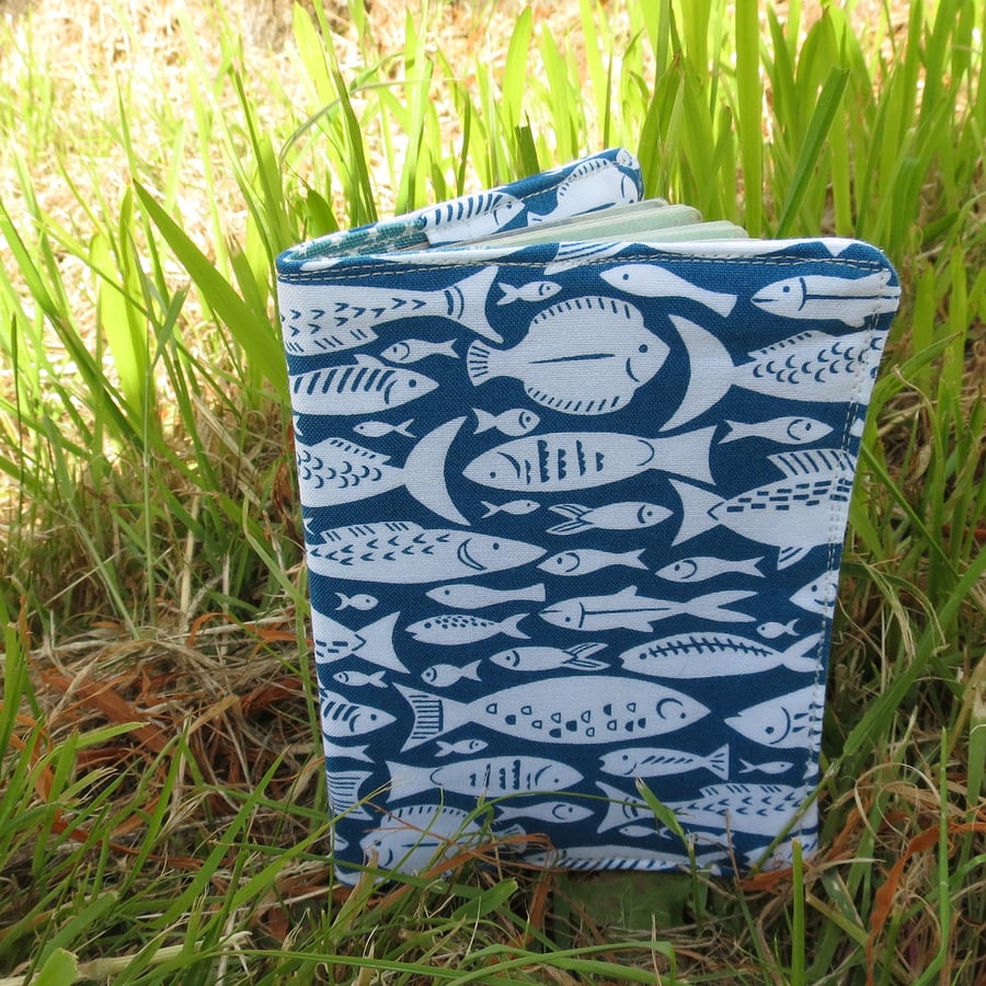 A passport cover with a fish design.  Passport sleeve.