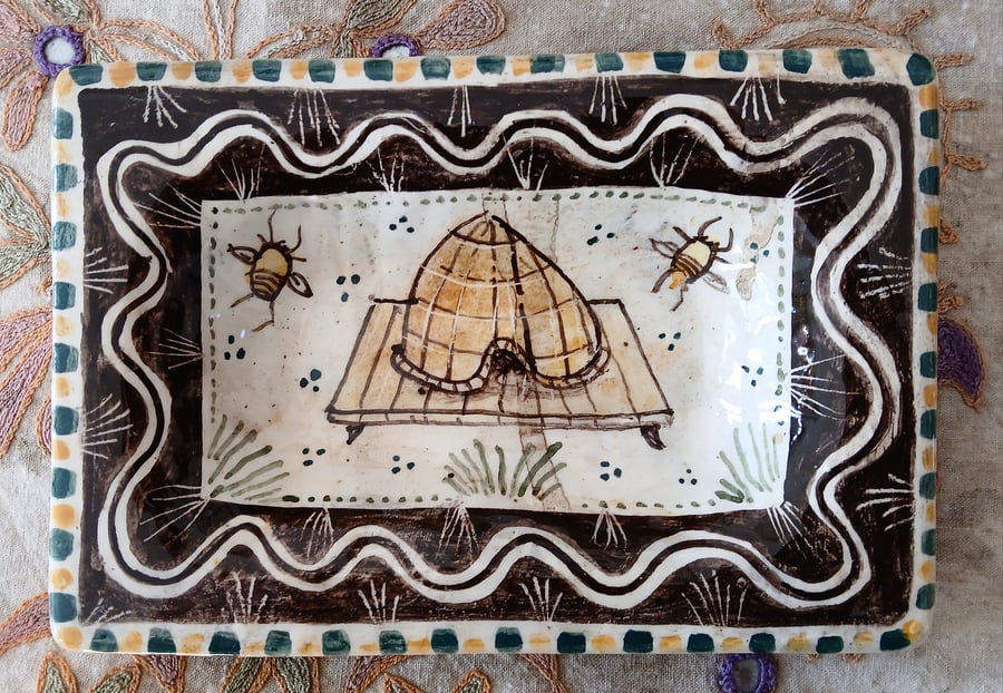 Square slip ware dish with hand painted bee skep