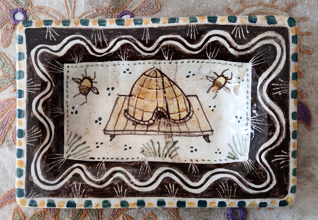 Square slip ware dish with hand painted bee skep