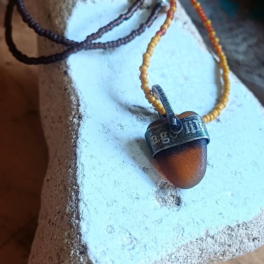 Brown-beer sea glass, silver and seed-bead swivel necklace pendant.