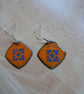 Square earrings with blue design on orange 