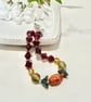Slender glass bead bracelet in earthy shades of red and orange.  - Image 1