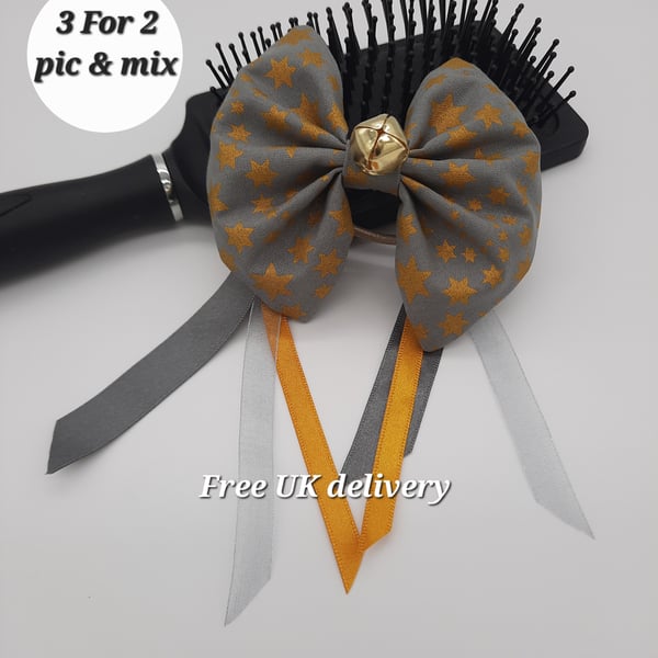 Hair bow grey gold star with ribbons and bell.  