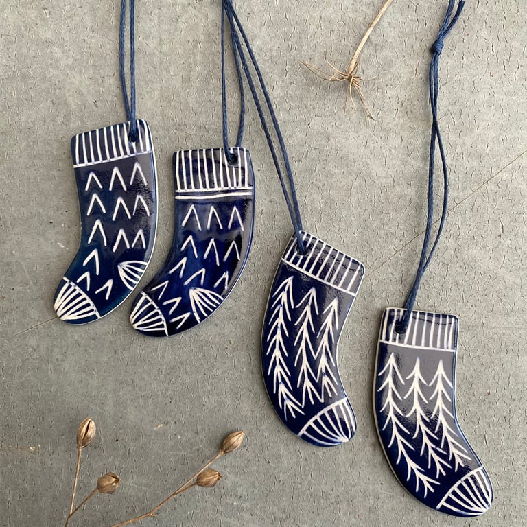Set of four ceramic sock decorations .