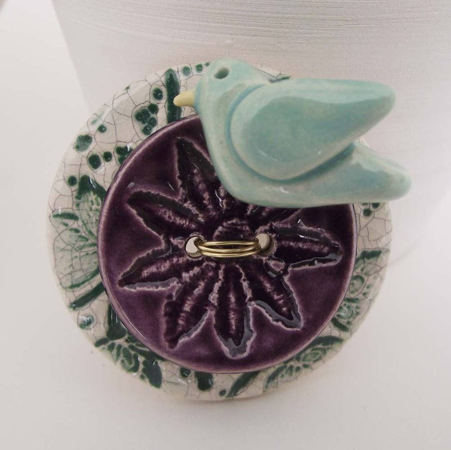 Ceramic bird on a button brooch