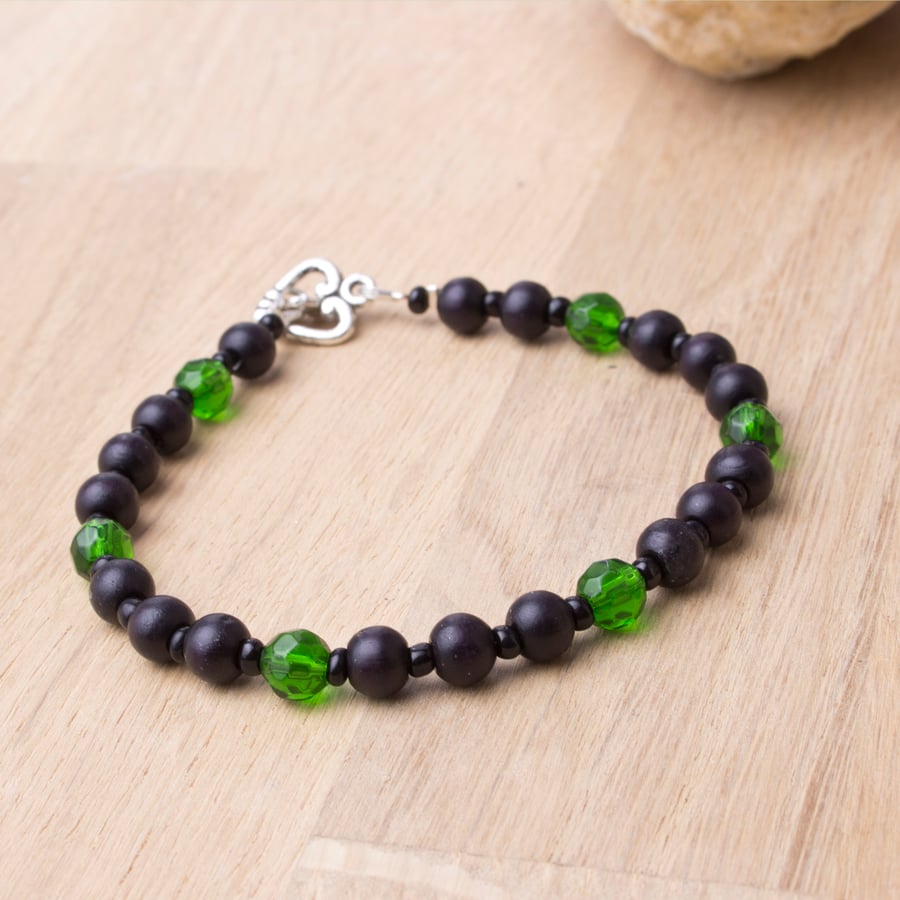 Bead bracelet - black wooden beads with green accents