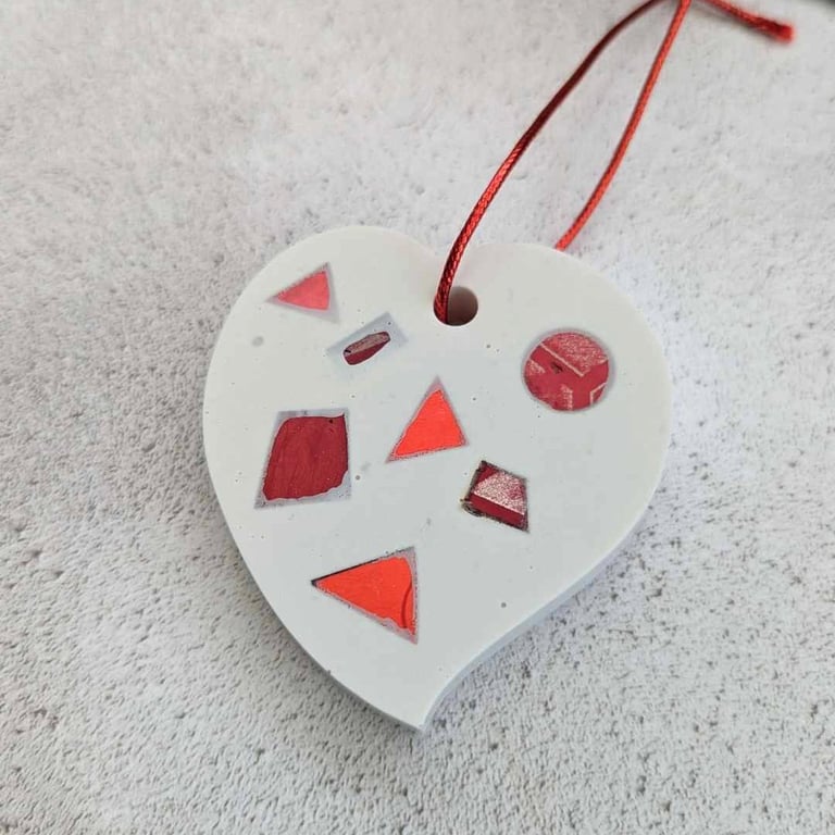 A handmade jesmonite heart filled with bright red hand dyed aluminium pieces