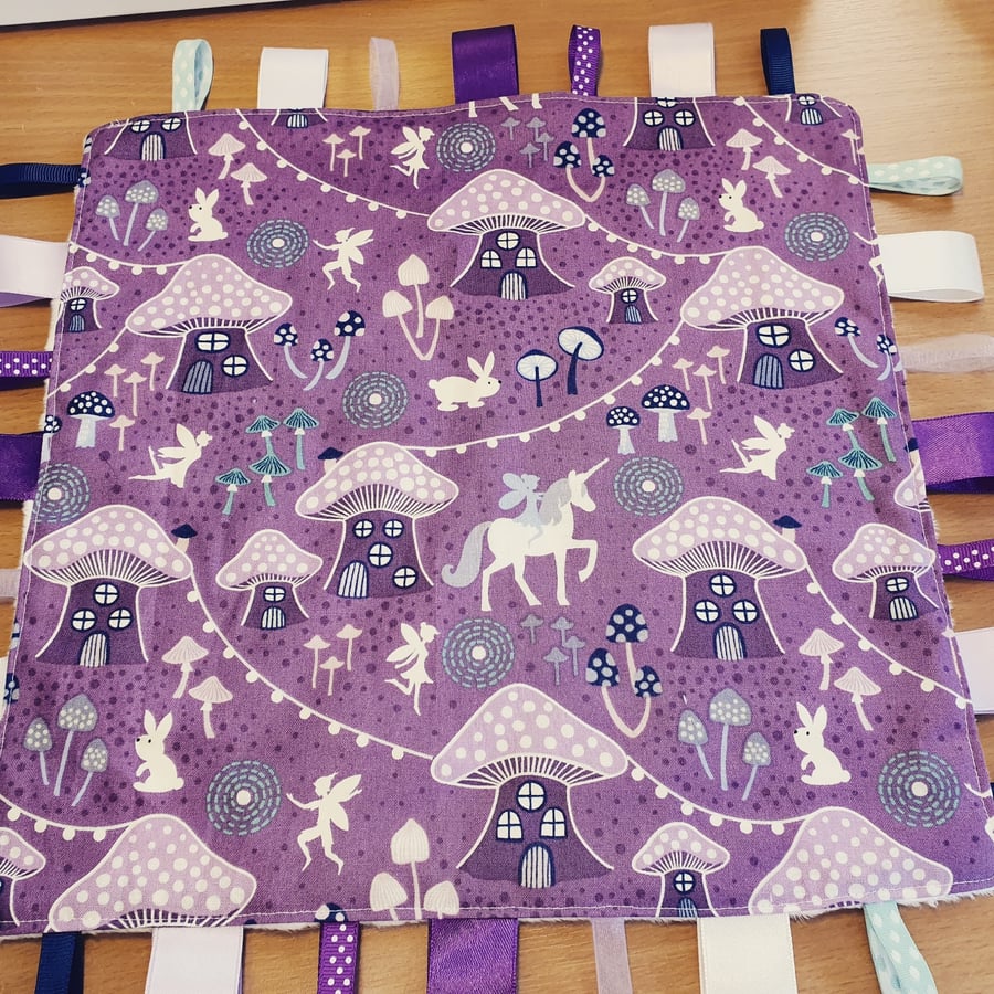 Purple glow-in-the-dark taggy blanket 