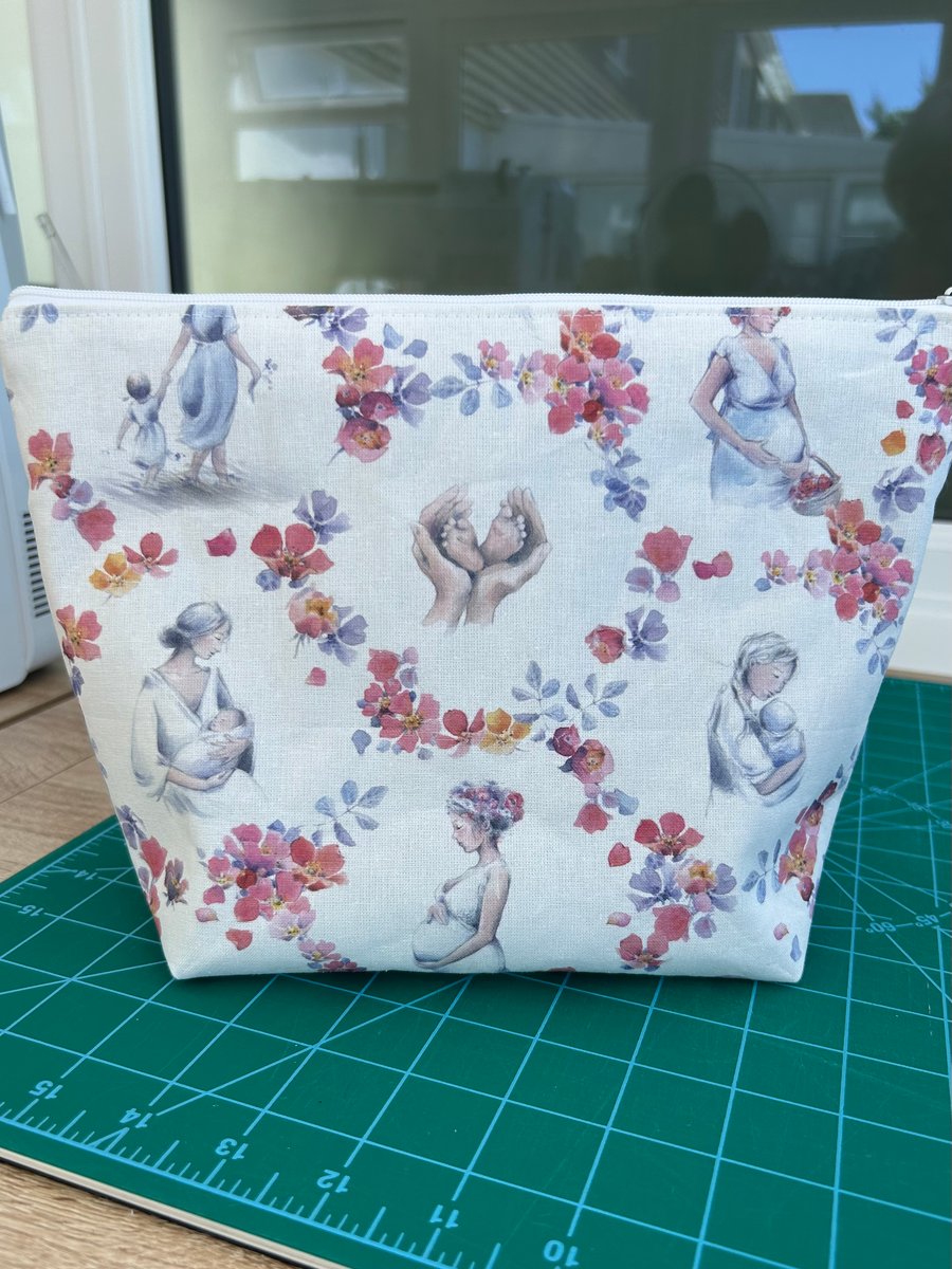 Fully lined zipper pouch in beautiful new parent and baby fabric.