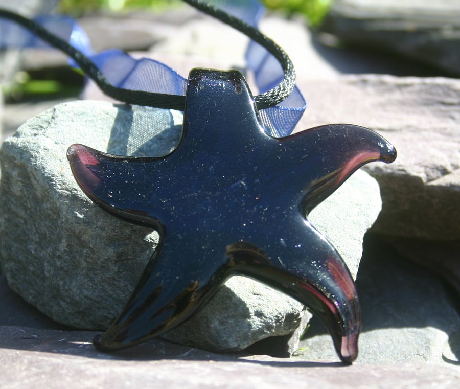 Sale 50% off. Glass star pendant strung on blue ribbon, black satin cord.