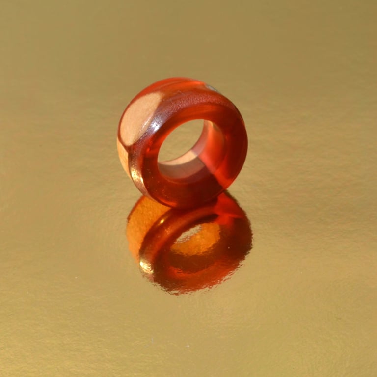 Epoxy Resin finger ring with wood inserts.