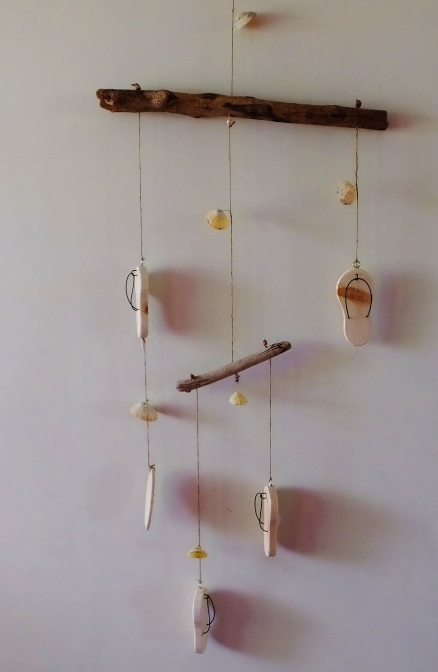 Driftwood mobile with wooden flip flops, surf board and sea shells decoration