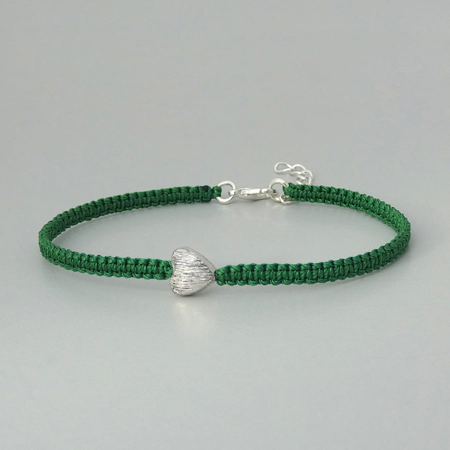 Green 7" macramé bracelet with silver plated heart charm and 1” extender chain.