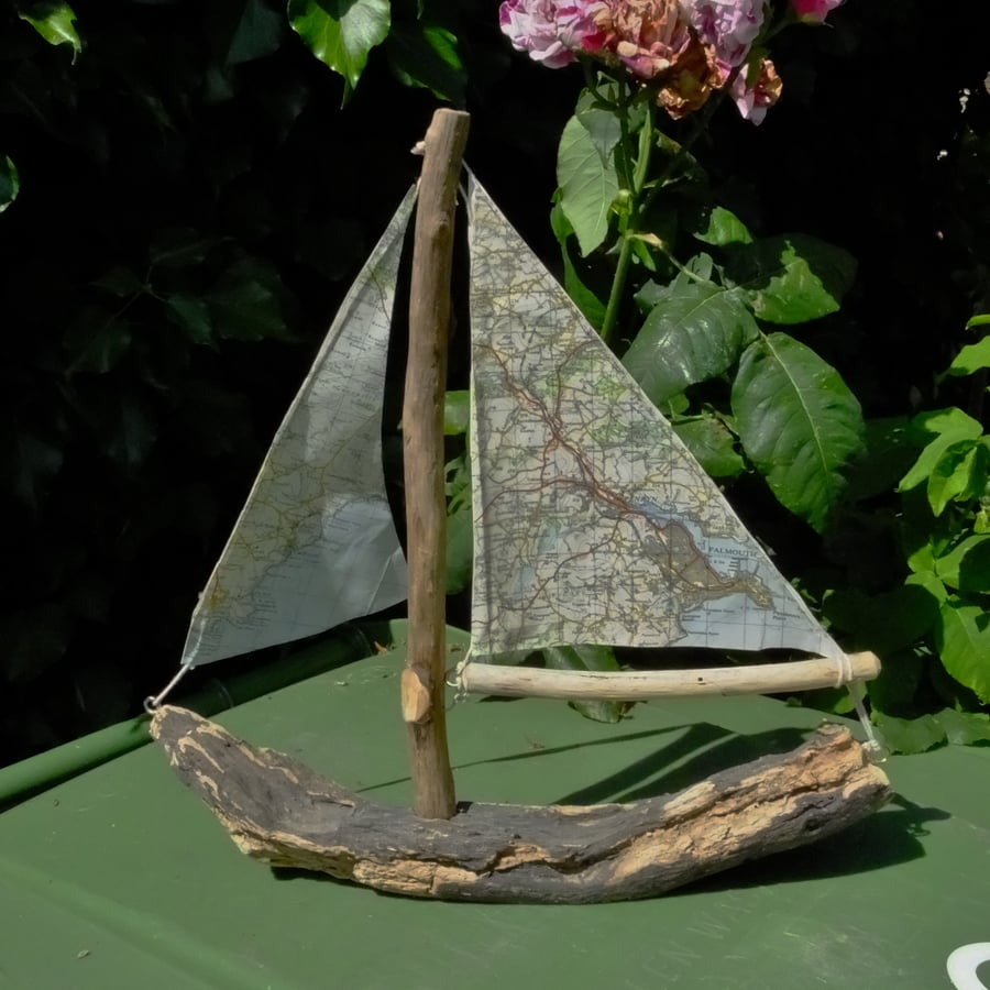 Little driftwood boat with Ordnance Survey map for sail Falmouth & Porthscatho