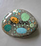 Hand painted pebble with believe design 3.5" x 3.5"