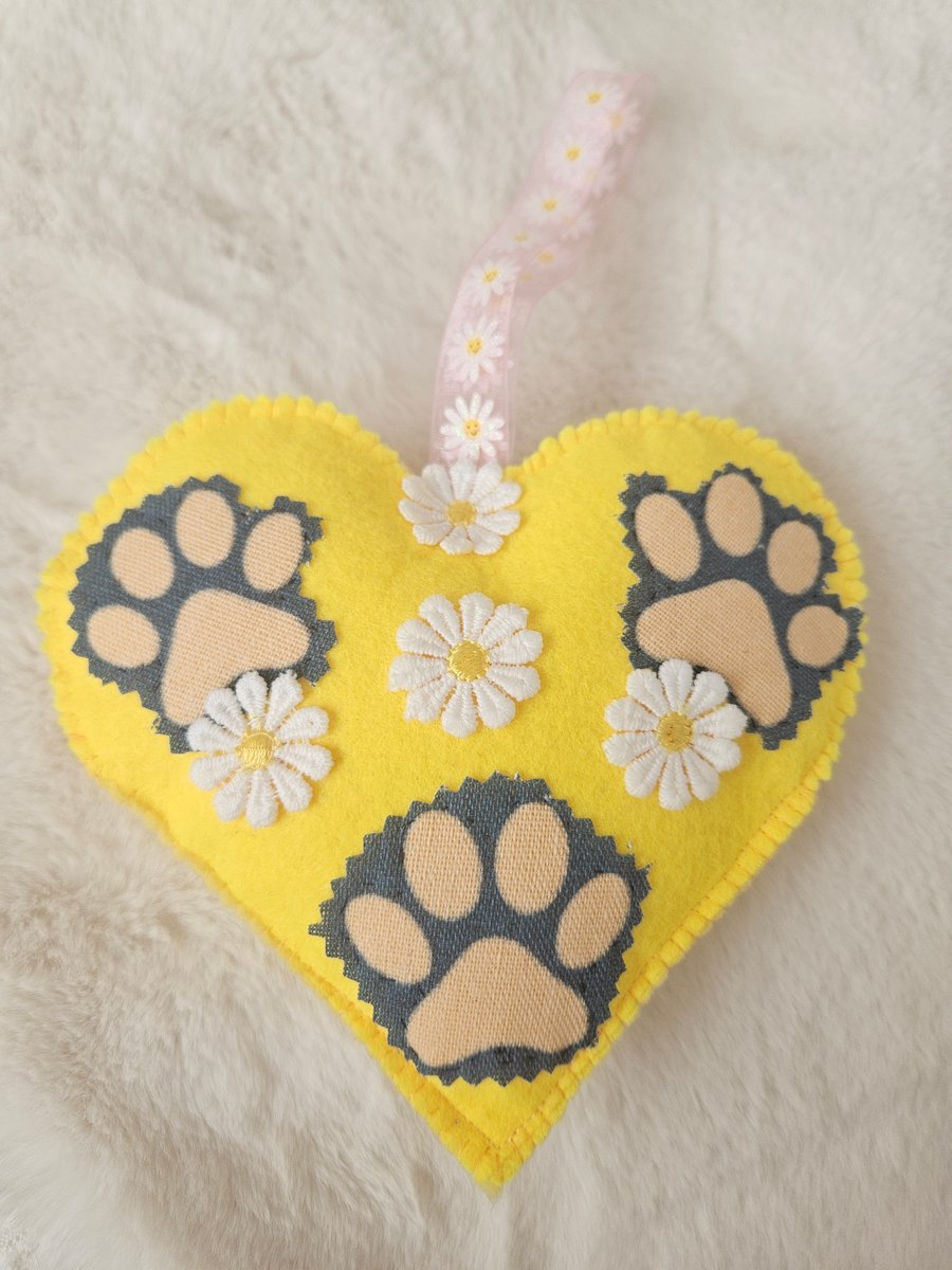 Hanging heart with pet paws and spring flowers