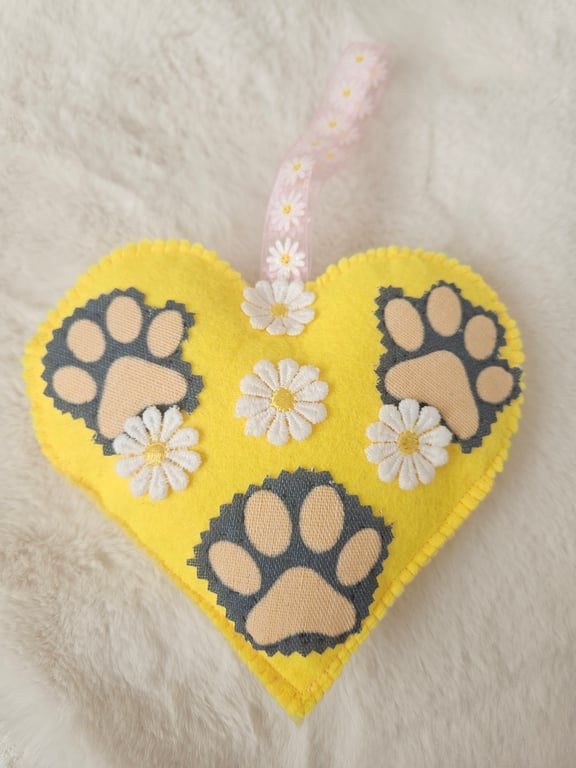 Hanging heart with pet paws and spring flowers