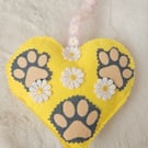 Hanging heart with pet paws and spring flowers