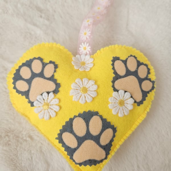 Hanging heart with pet paws and spring flowers