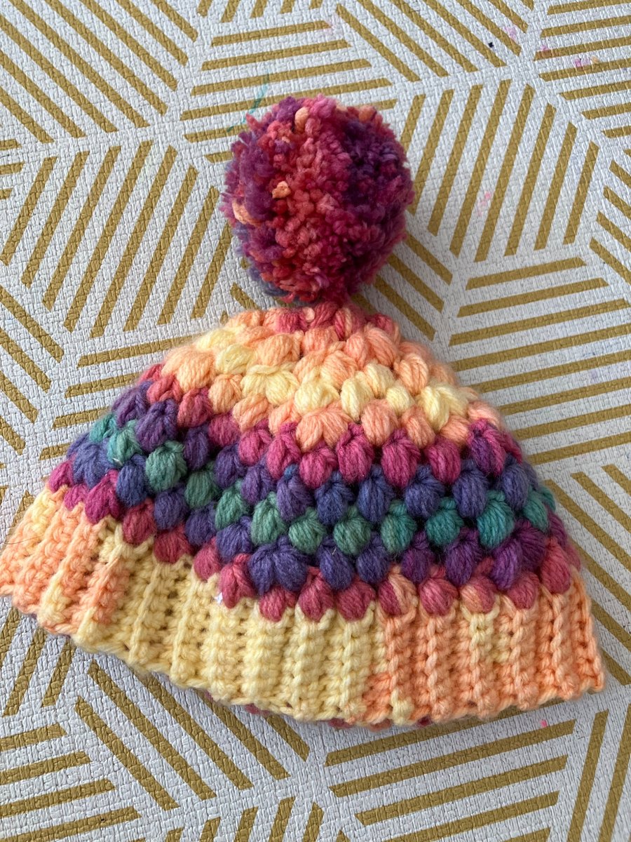 Crochet cosy rainbow Pom Pom bobble hat
