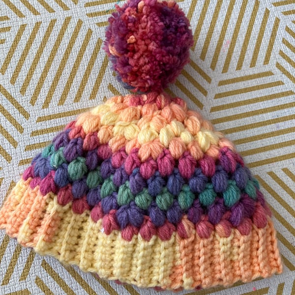Crochet cosy rainbow Pom Pom bobble hat