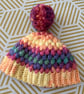 Crochet cosy rainbow Pom Pom bobble hat